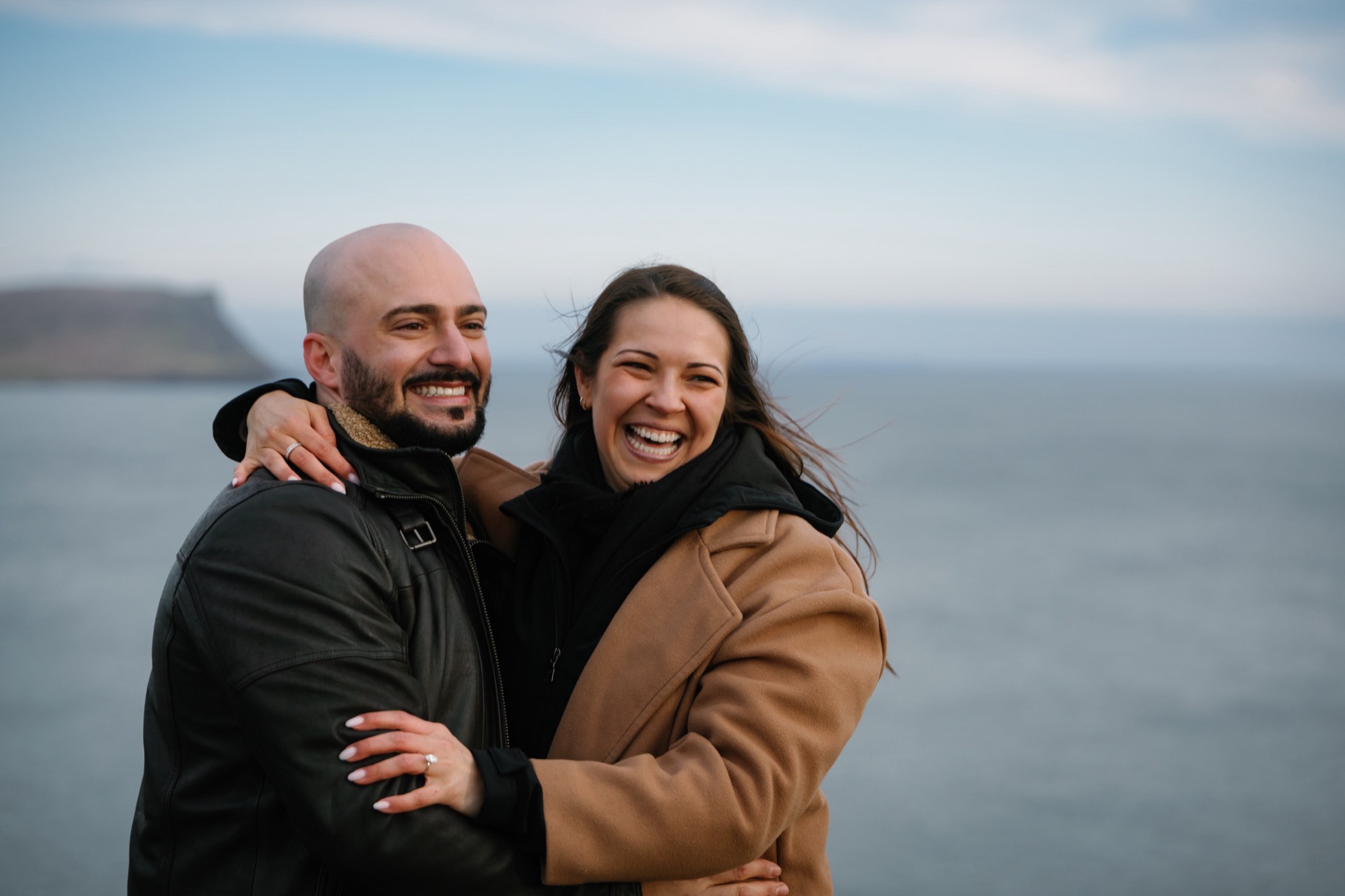 Danielle and Daniele laughing, arms around each other