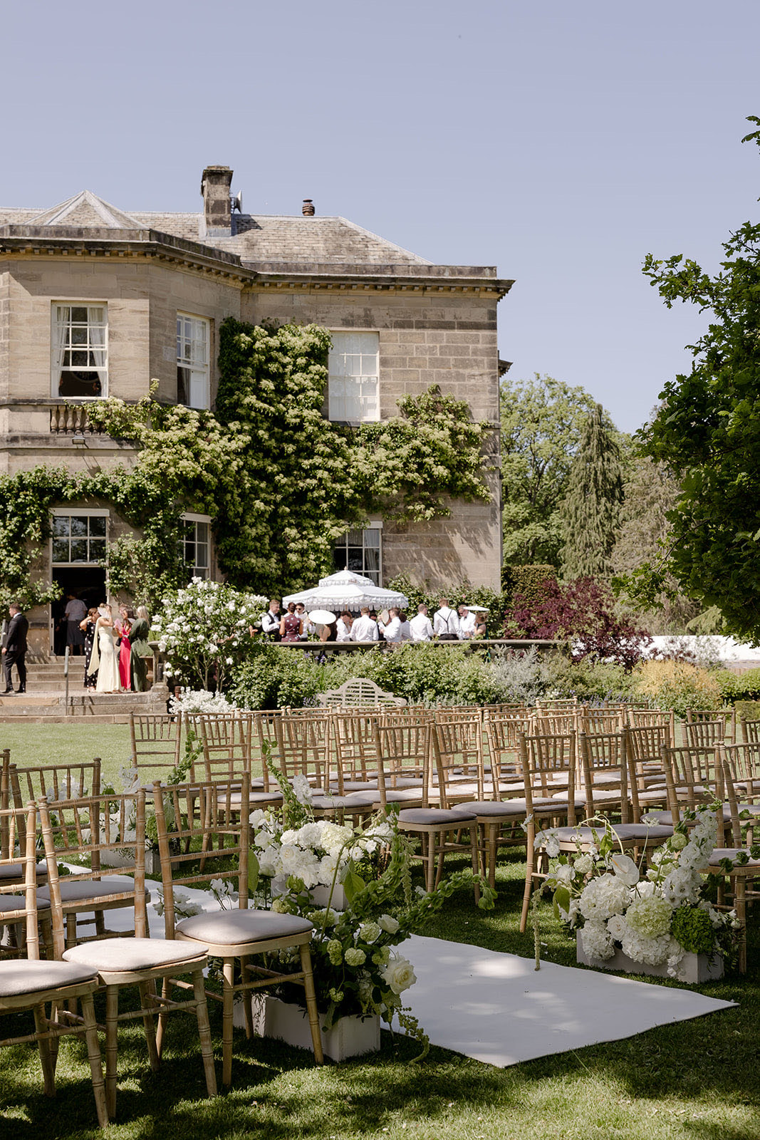 Chairs set out on the lawn for a ceremony, the house behind
